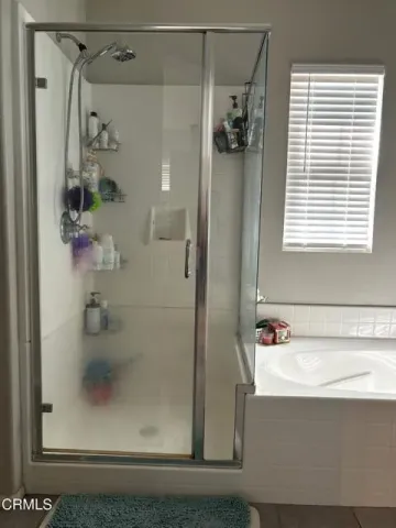 a bathroom with a shower and a sink