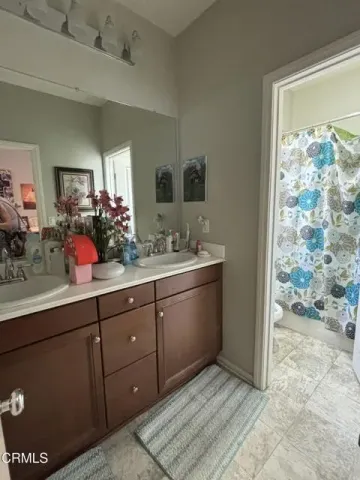 a bathroom with a sink mirror and vanity