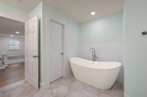 a white bath tub sitting in a bathroom
