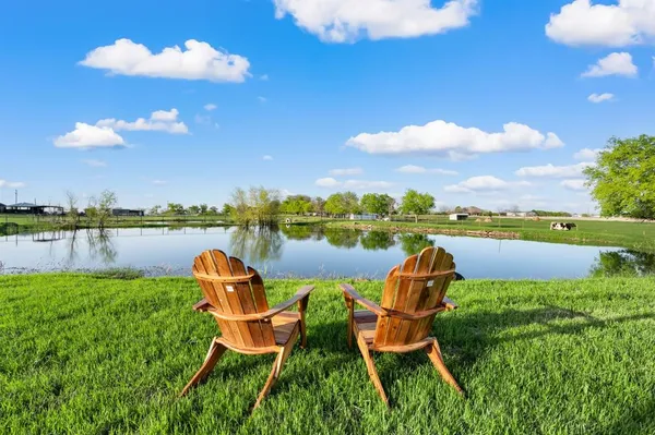 a view of a lake with a lounge chair