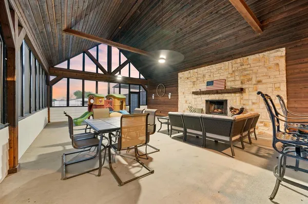 a outdoor space with patio furniture and a fireplace