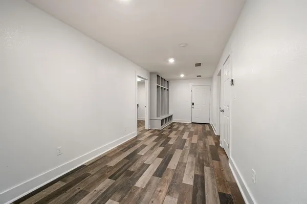 a view of a room with wooden floor