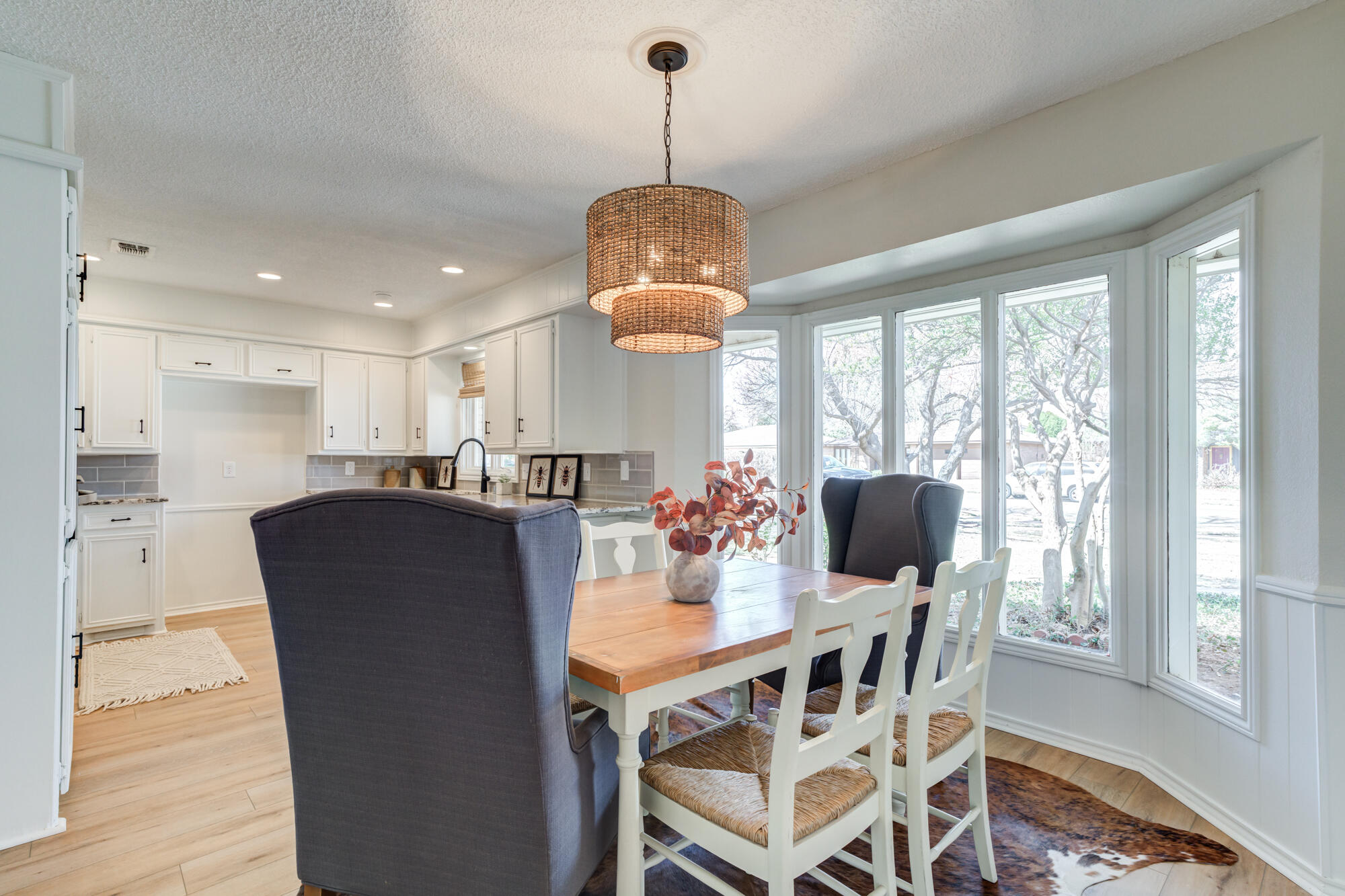 3405 91st Street Lubbock, TX 79423 - Photo 17 of 41 a dining room with furniture a chandelier and wooden floor
