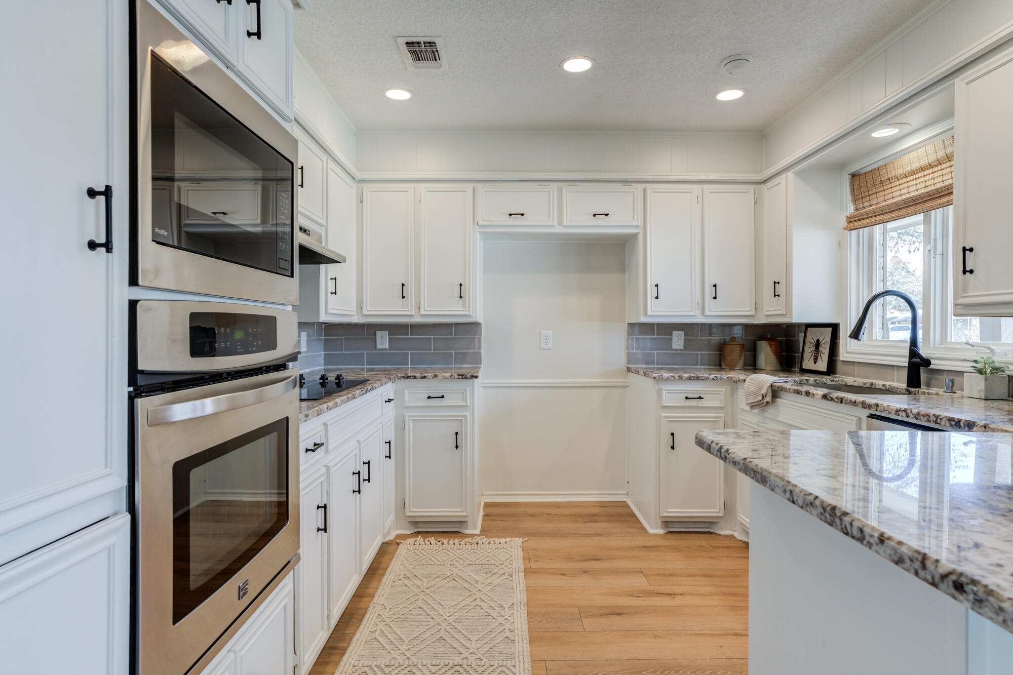 3405 91st Street Lubbock, TX 79423 - Photo 19 of 41 a kitchen with a sink stove and microwave