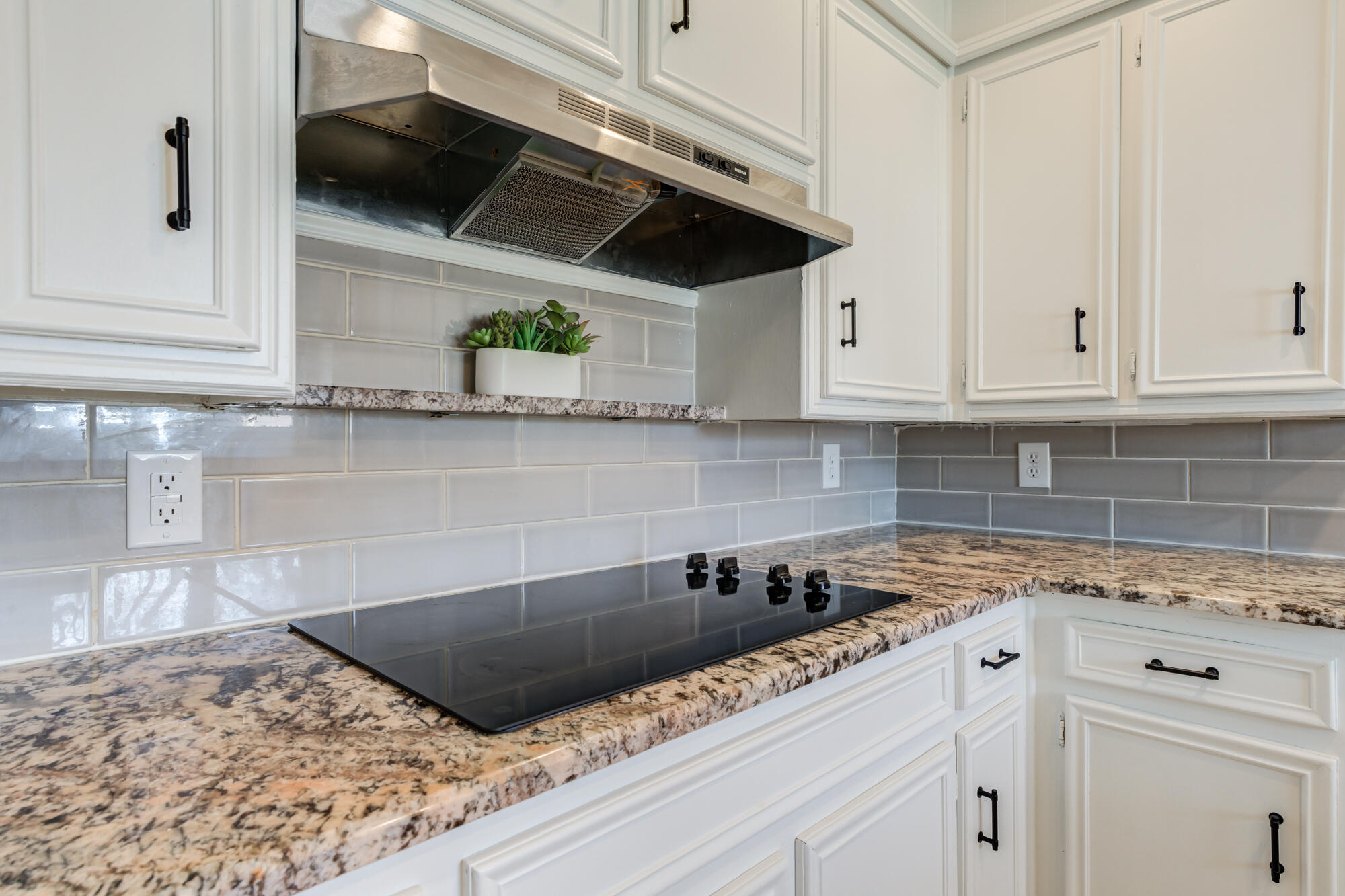 3405 91st Street Lubbock, TX 79423 - Photo 21 of 41 a kitchen with stainless steel appliances granite countertop a sink a stove and white cabinets
