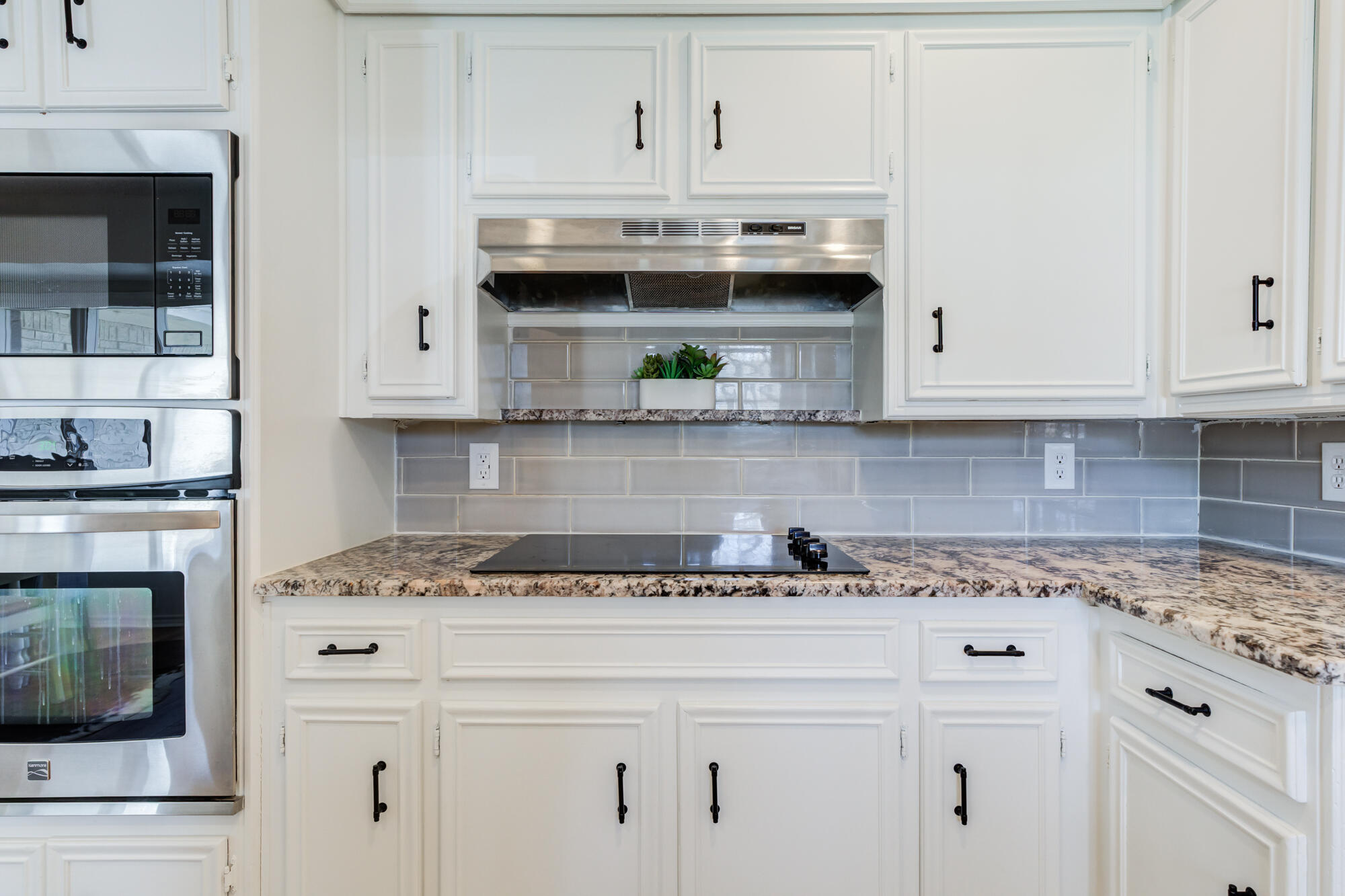 3405 91st Street Lubbock, TX 79423 - Photo 22 of 41 a kitchen with granite countertop white cabinets and a stove