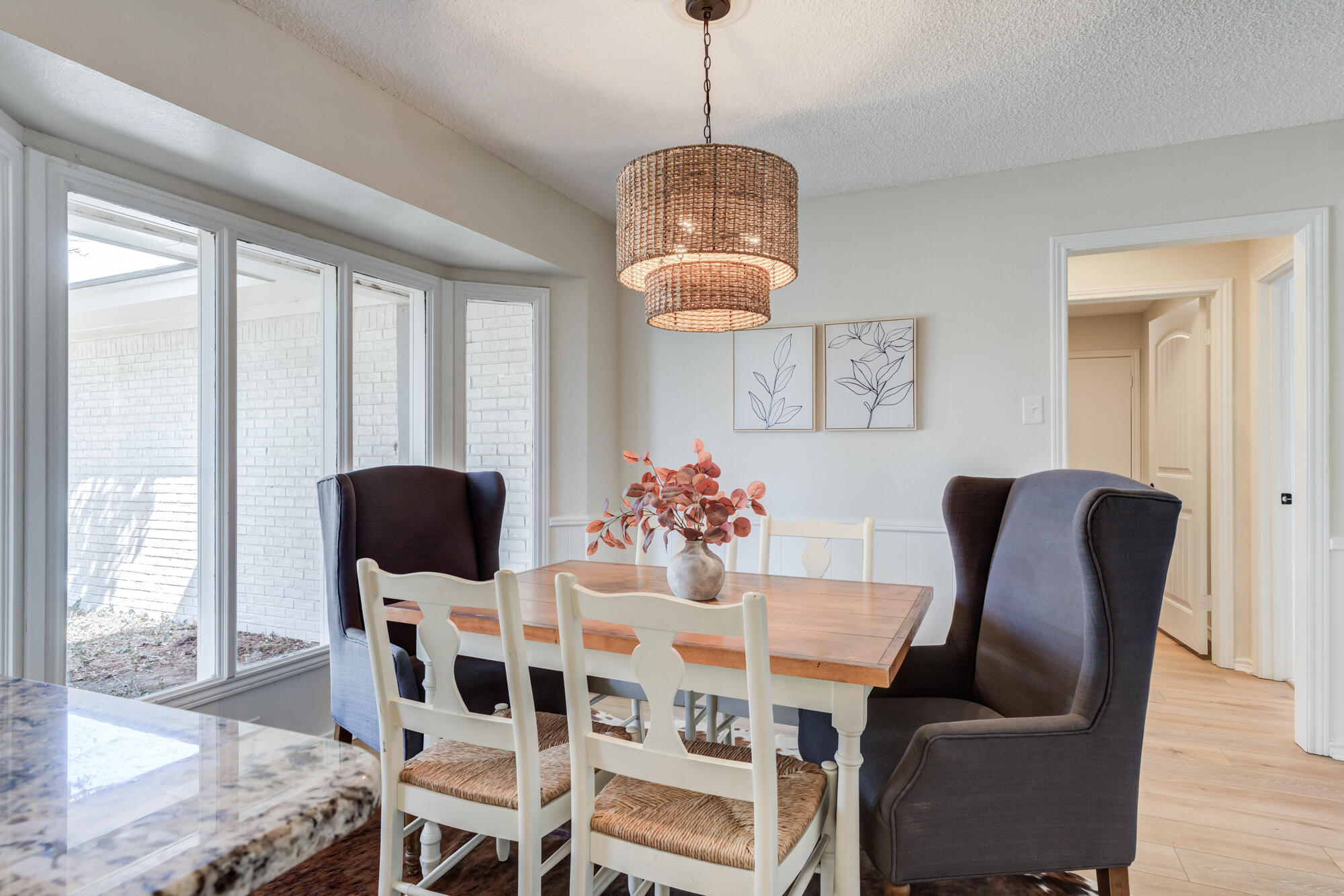 3405 91st Street Lubbock, TX 79423 - Photo 25 of 41 a view of a dining room with furniture wooden floor and chandelier