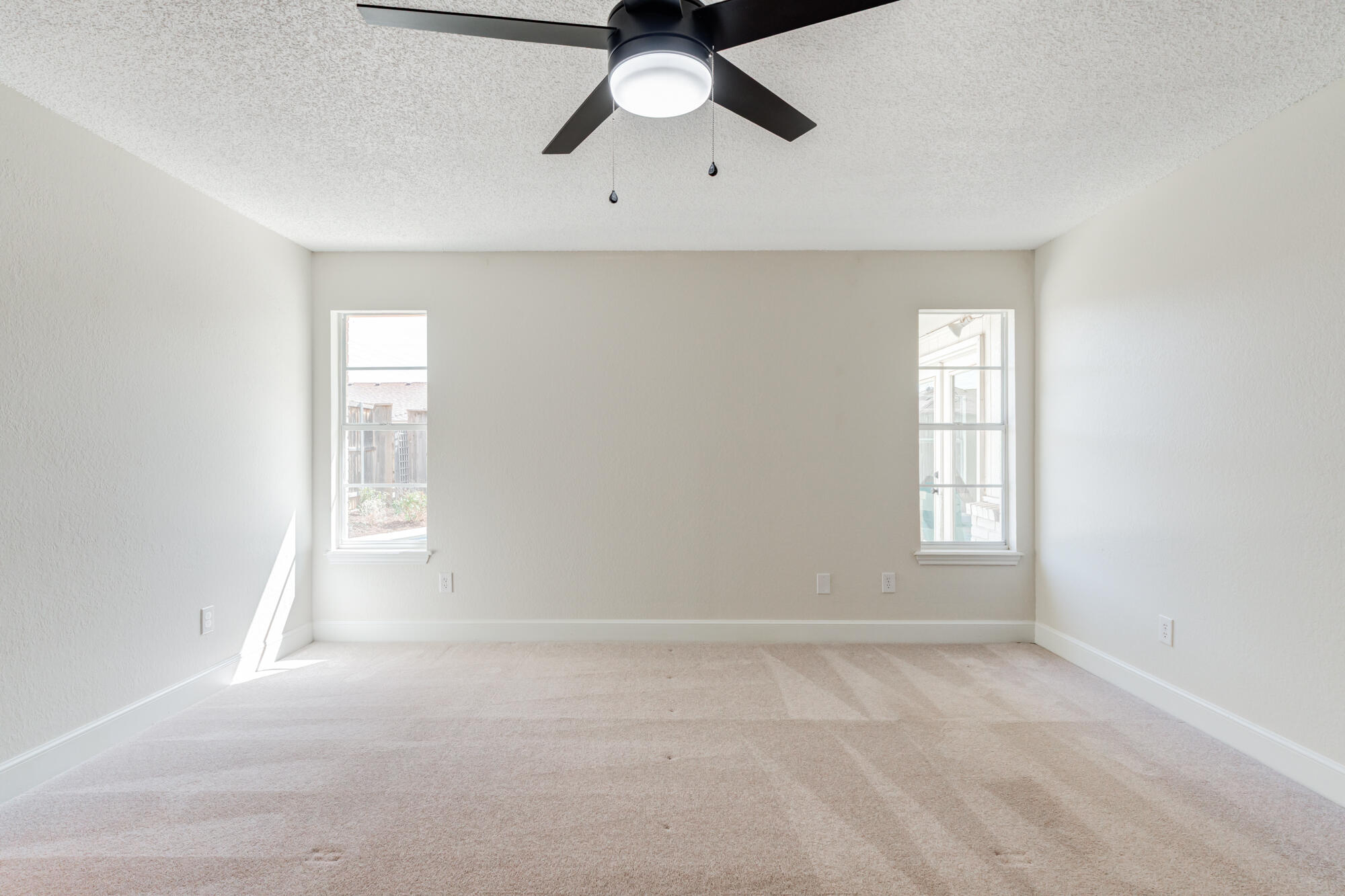 3405 91st Street Lubbock, TX 79423 - Photo 28 of 41 an empty room with a window and a ceiling fan