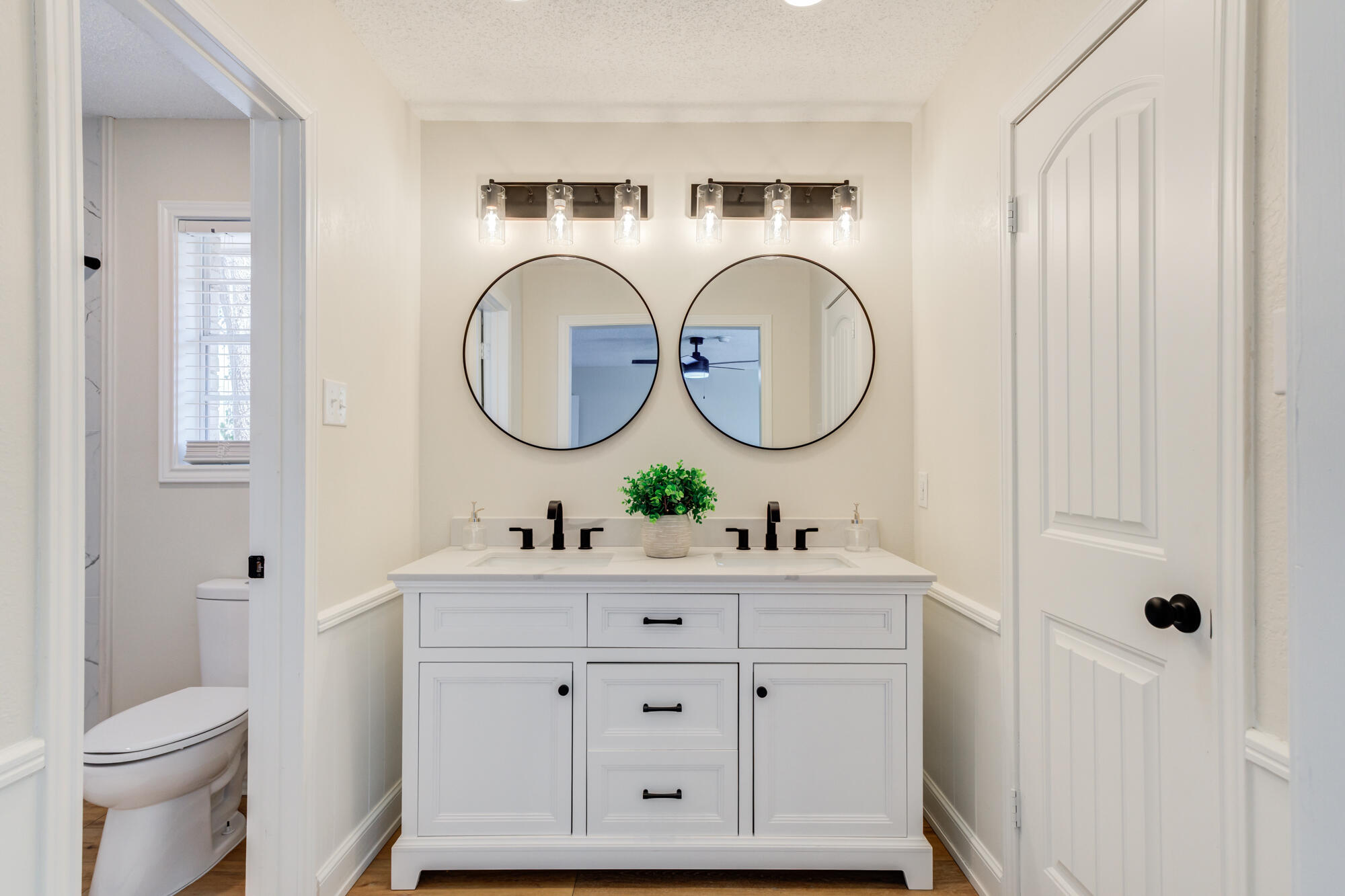 3405 91st Street Lubbock, TX 79423 - Photo 29 of 41 a bathroom with a sink mirror vanity and toilet