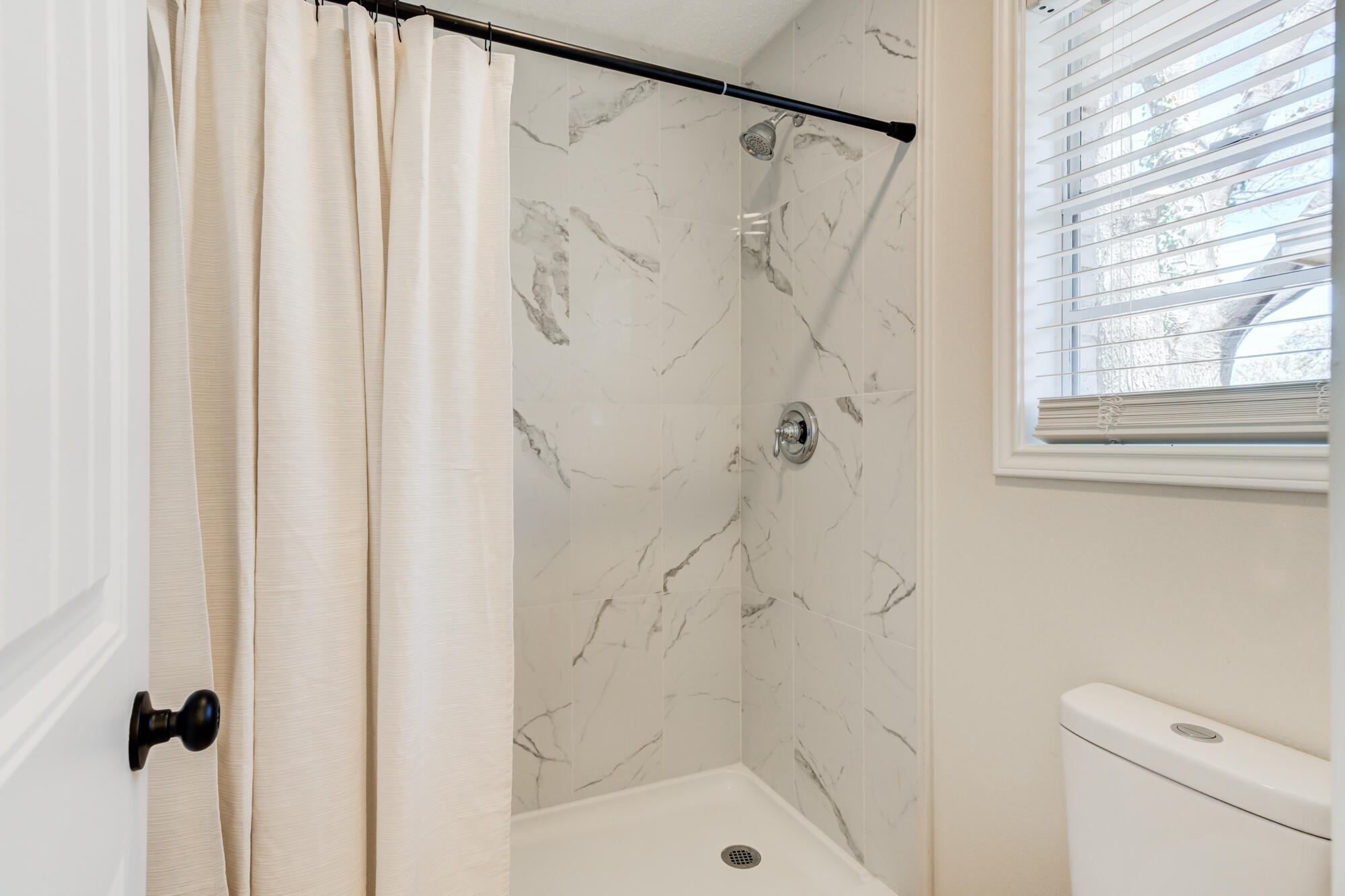 3405 91st Street Lubbock, TX 79423 - Photo 30 of 41 a bathroom with a shower and a toilet