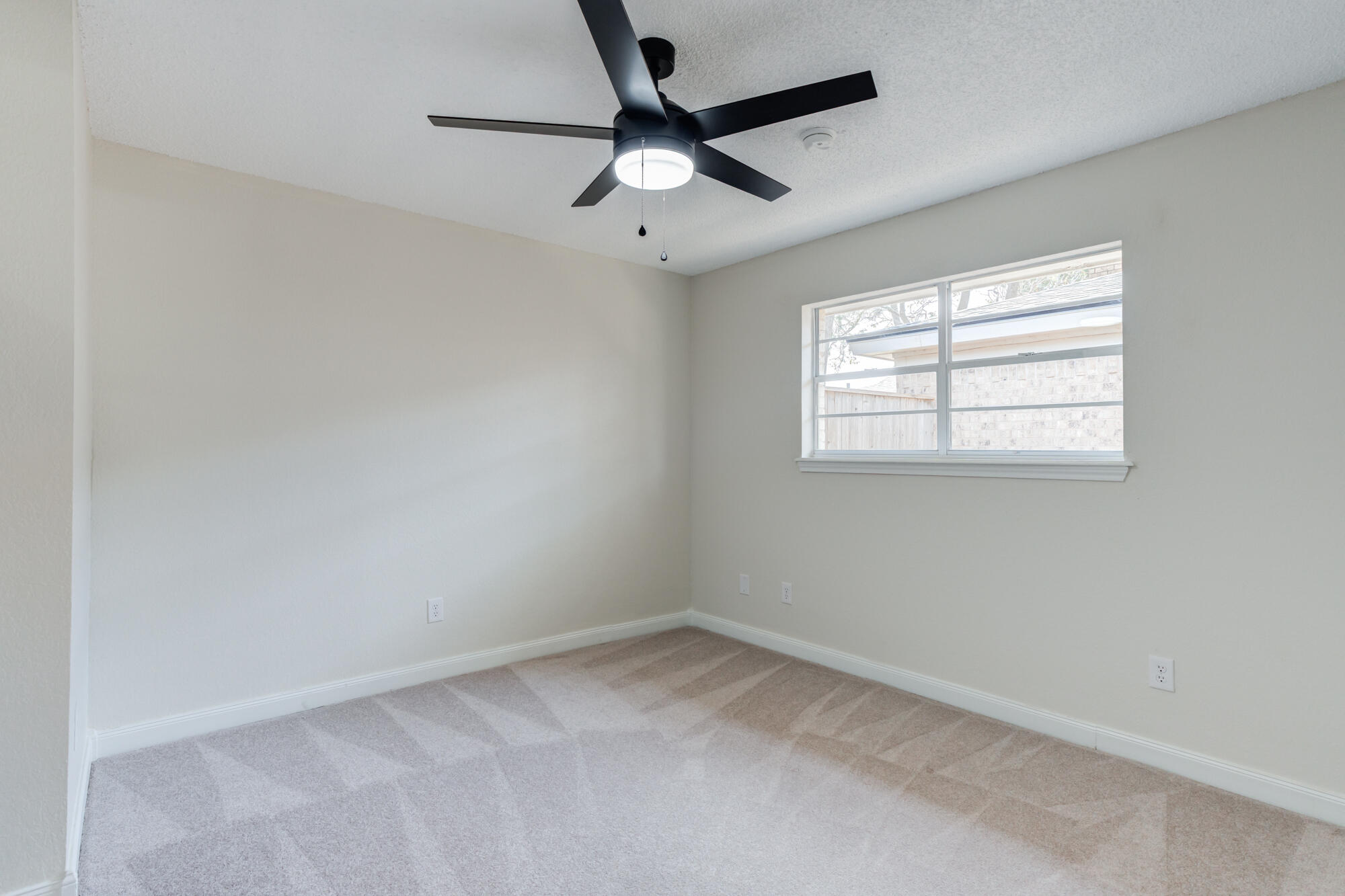3405 91st Street Lubbock, TX 79423 - Photo 36 of 41 an empty room with a window and a fan