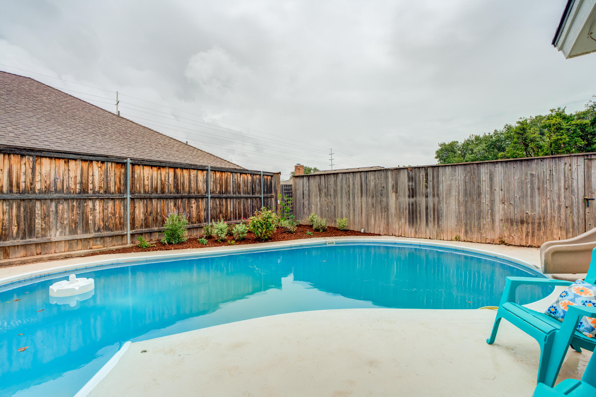 3405 91st Street Lubbock, TX 79423 - Photo 38 of 41 a view of swimming pool with seating area and small garden in the background