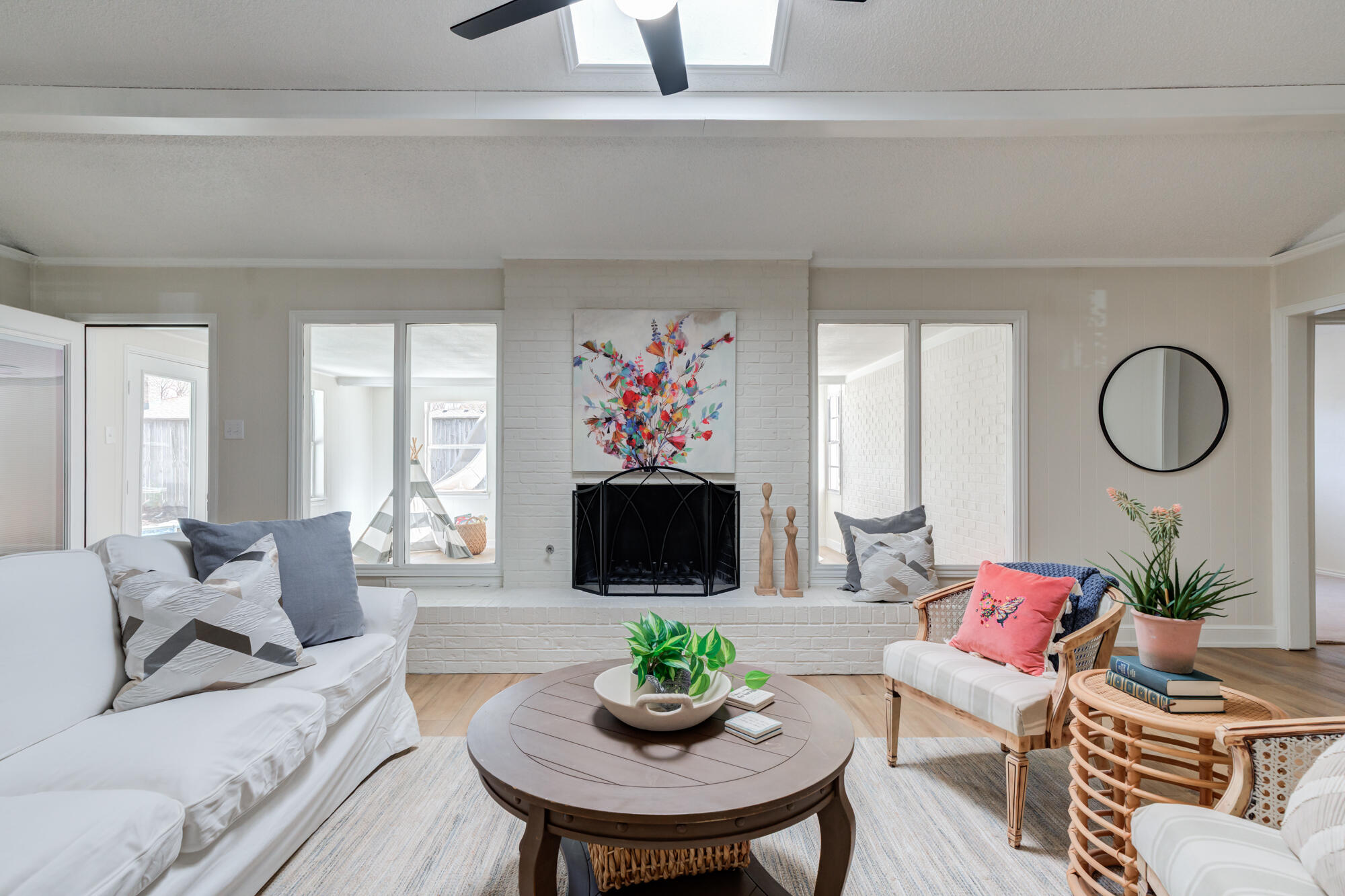 3405 91st Street Lubbock, TX 79423 - Photo 8 of 41 a living room with furniture a mirror and a flat screen tv