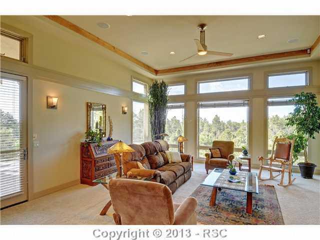 4265 Hidden Rock Road Colorado Springs, CO 80908 - Photo 4 of 25 Living Room/Great Room with Large Windows, Beautiful Views, 3-Sided Gas Fireplace & Walk-out to Deck