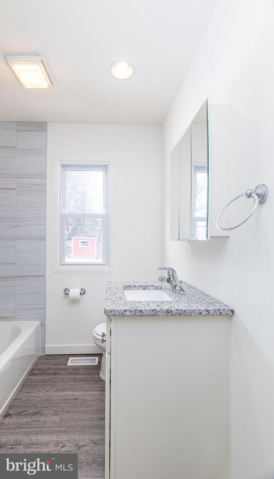 8 South Reed Street Bel Air, MD 21014 - Photo 11 of 21 a bathroom with a granite countertop sink and a mirror