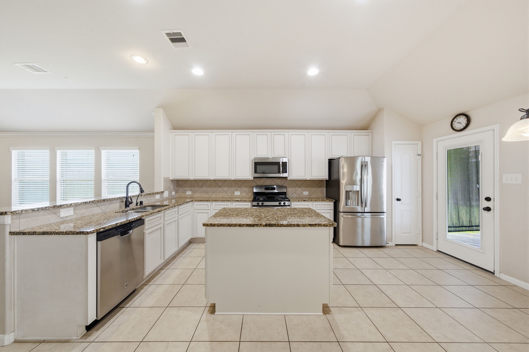 7611 Willow School Drive Spring, TX 77389 - Photo 9 of 23 a kitchen with stainless steel appliances granite countertop a sink and a refrigerator