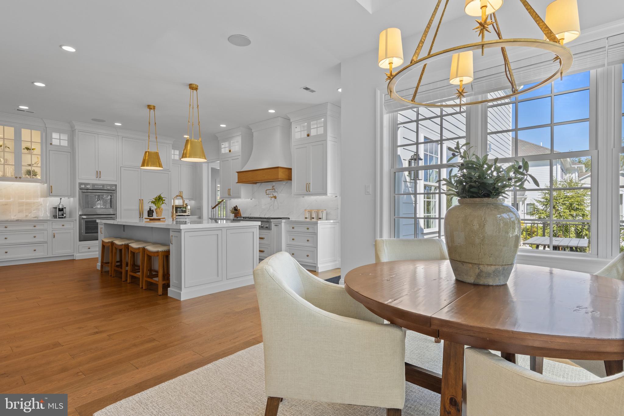 1052 Prescott Road Berwyn, PA 19312 - Photo 13 of 65 a kitchen with stainless steel appliances granite countertop a table chairs and a refrigerator