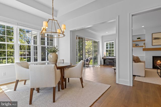 a living room with furniture and floor to ceiling windows