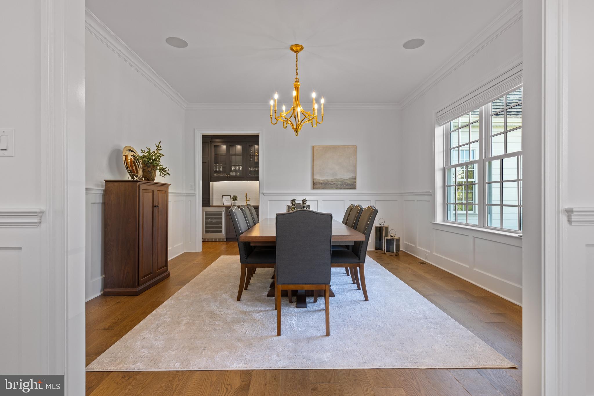 1052 Prescott Road Berwyn, PA 19312 - Photo 17 of 65 a living room with furniture a dining table and a refrigerator