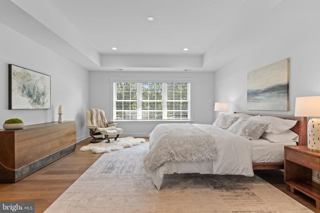 a bedroom with bed and a table