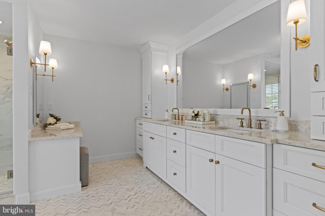 a view of a hallway with furniture and wooden floor