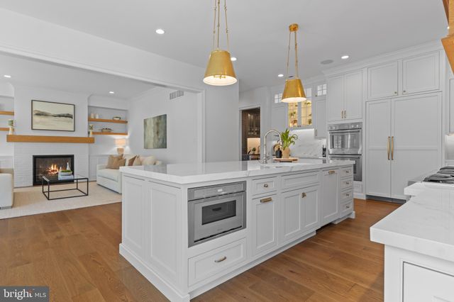 a living room with furniture a dining table and a refrigerator