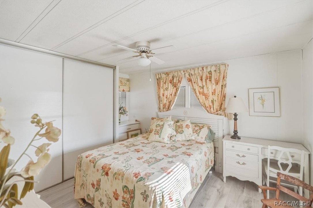 928 South Shad Terrace Inverness, FL 34450 - Photo 22 of 48 a bedroom with a large bed and a chandelier