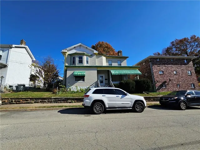 a view of a car parked in front of a house