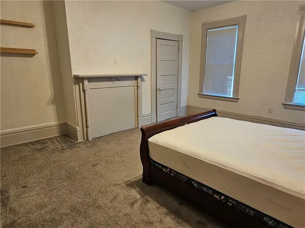 a bedroom with a bed and hallway