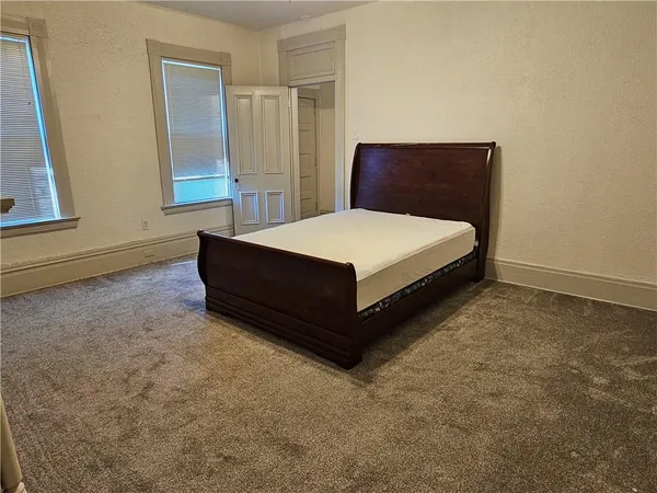 a room with a bed and window