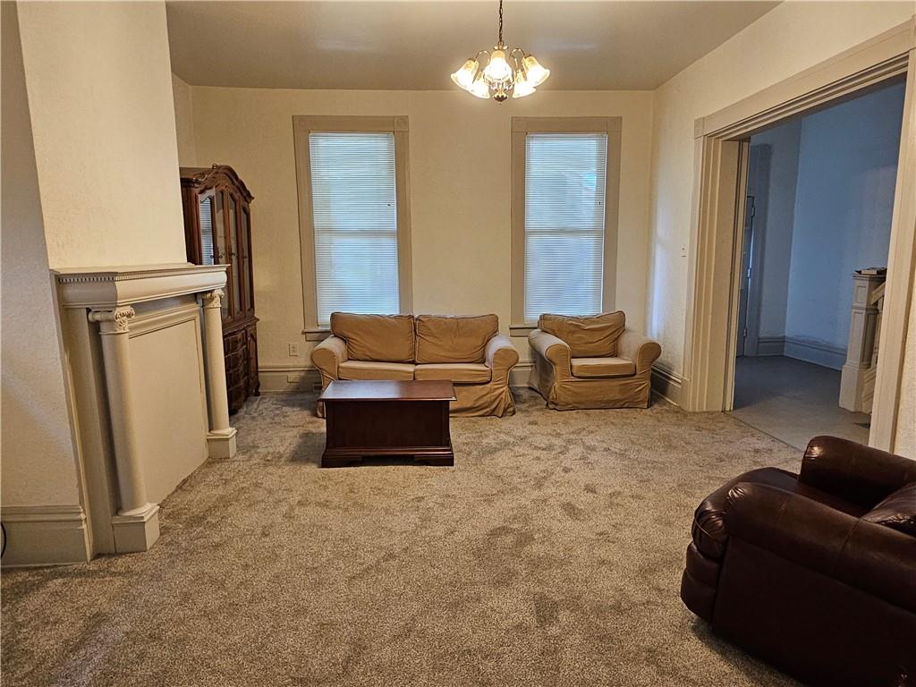 629 R Walnut Street Irwin, PA 15642 - Photo 6 of 25 a living room with furniture a fireplace and a chandelier