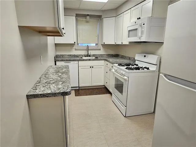 a kitchen with stainless steel appliances granite countertop a sink and a stove