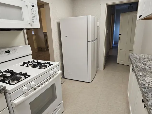 a kitchen with a stove and a refrigerator
