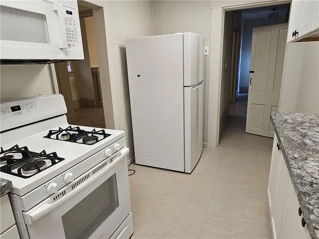 a kitchen with a stove and a refrigerator