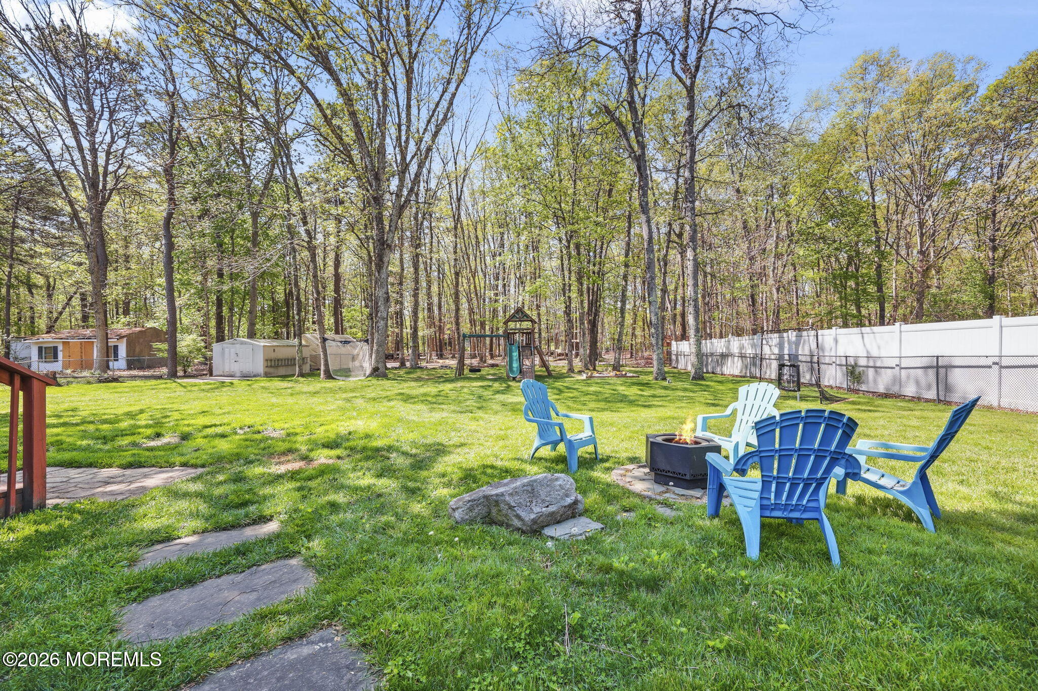 356 Leesville Road Jackson, NJ 08527 - Photo 36 of 46 a chair and table sitting in the grass near a yard