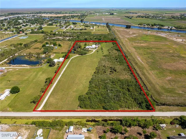 an aerial view of a residential houses with outdoor space