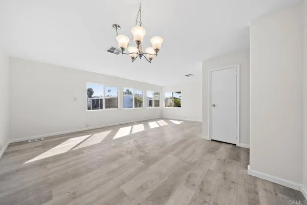 a view of an empty room with a chandelier