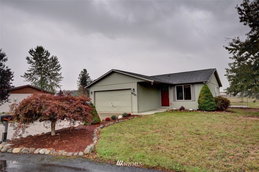 4121 Violet Court Southwest Rochester, WA 98579 - Photo 1 of 21 a front view of house with yard and trees in the background