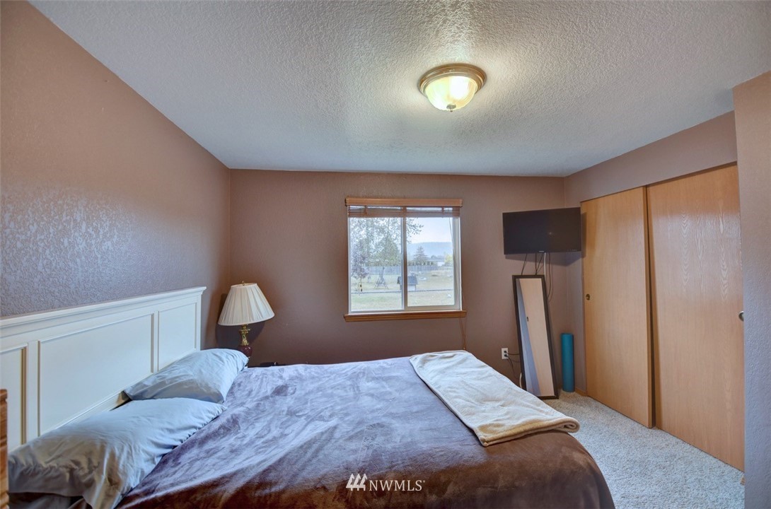 4121 Violet Court Southwest Rochester, WA 98579 - Photo 11 of 21 a bedroom with a bed and a window