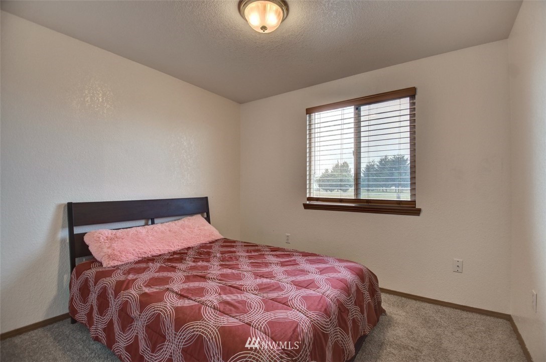 4121 Violet Court Southwest Rochester, WA 98579 - Photo 14 of 21 a bed sitting in a bedroom next to a window