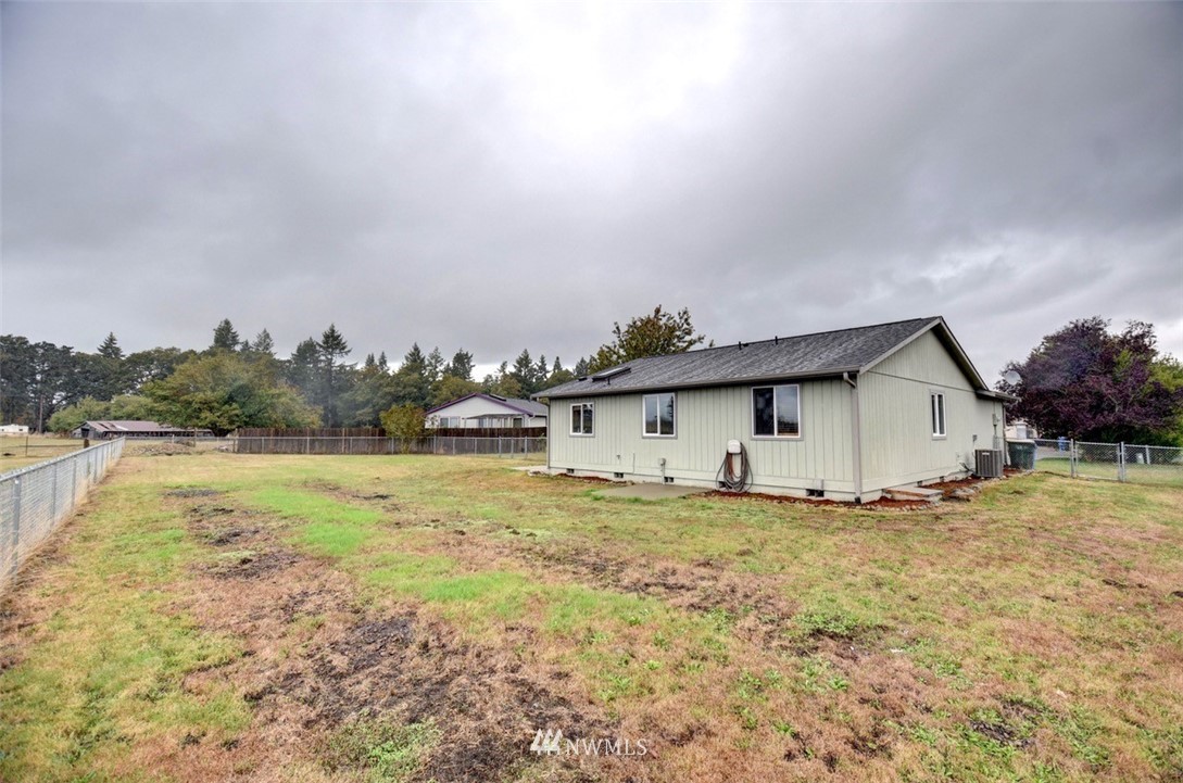 4121 Violet Court Southwest Rochester, WA 98579 - Photo 19 of 21 a view of a house with a yard and lake view