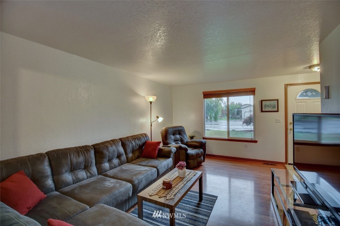 4121 Violet Court Southwest Rochester, WA 98579 - Photo 3 of 21 a living room with furniture a flat screen tv and wooden floor