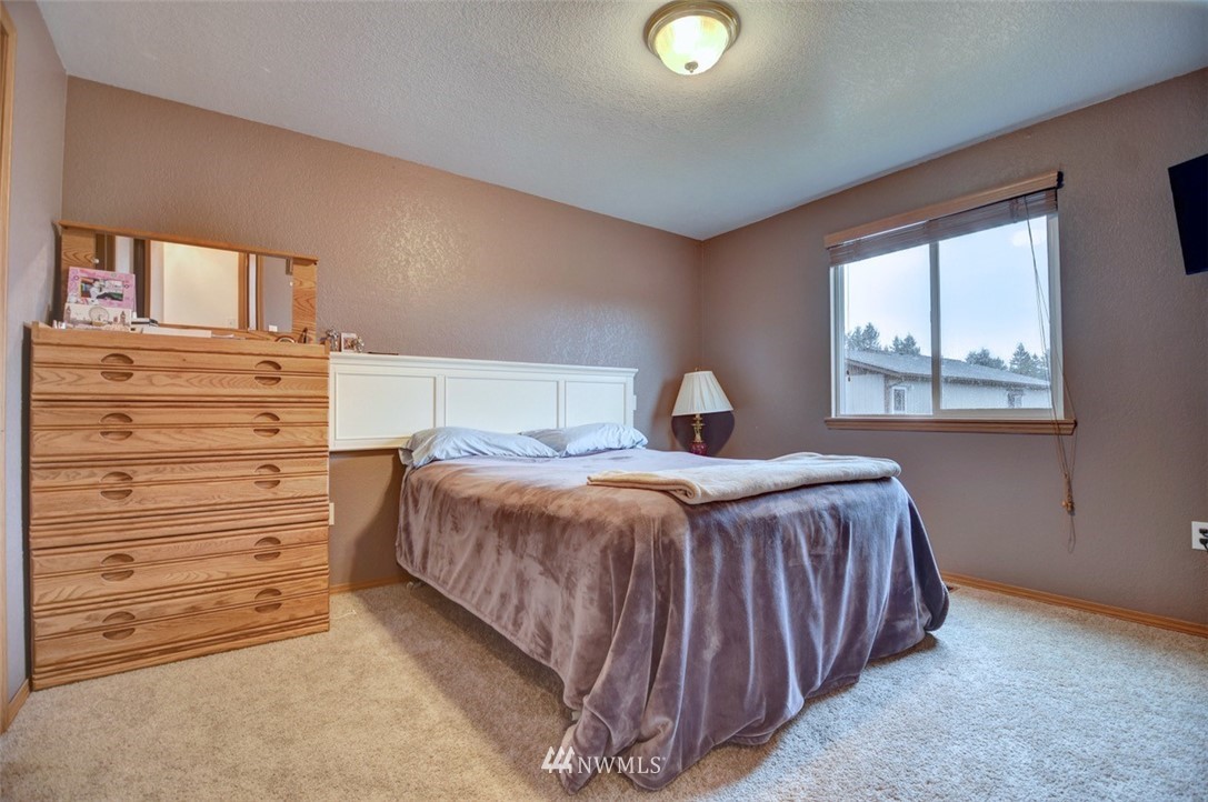 4121 Violet Court Southwest Rochester, WA 98579 - Photo 9 of 21 a bedroom with a bed and a window