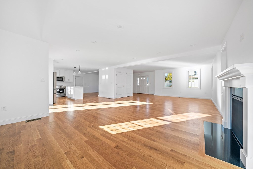 1 Northway Road Randolph, MA 02368 - Photo 11 of 40 a view of a living room with kitchen island wooden floor and a fireplace