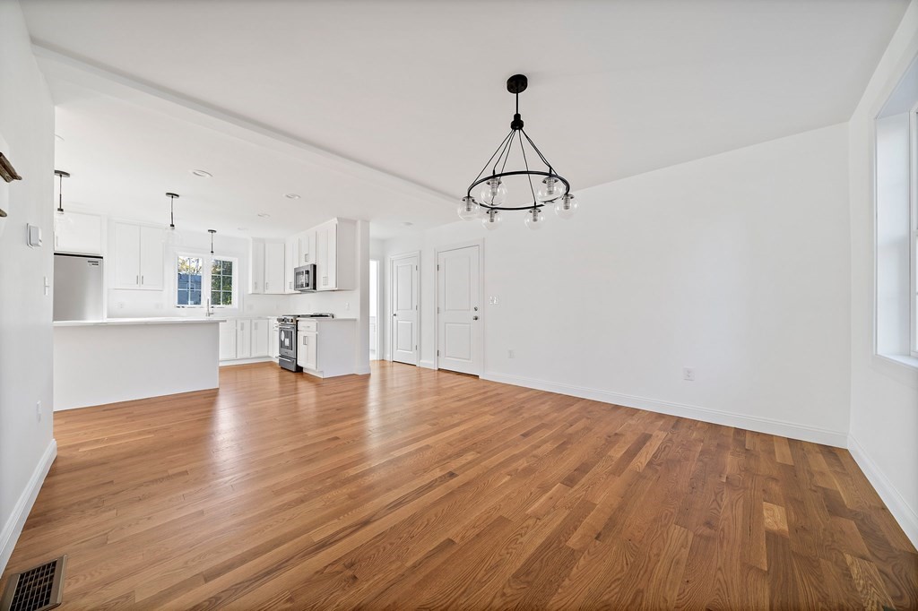 1 Northway Road Randolph, MA 02368 - Photo 14 of 40 a view of empty room with wooden floor and ceiling fan