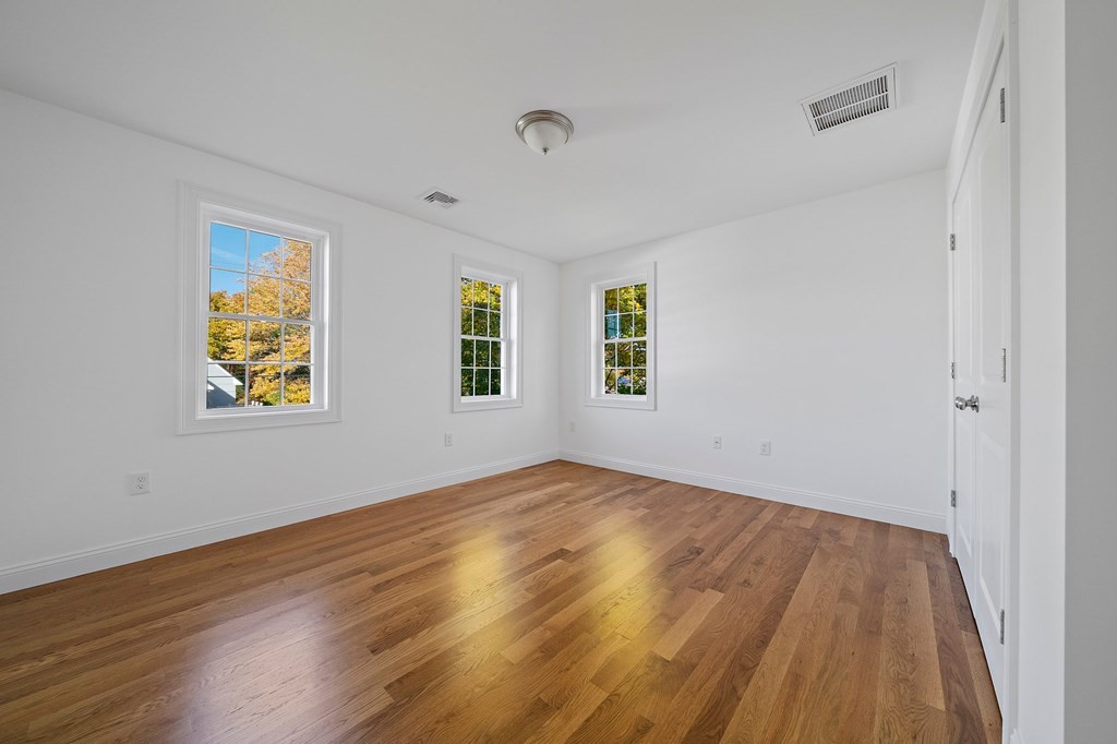 1 Northway Road Randolph, MA 02368 - Photo 19 of 40 a view of room with window and wooden floor