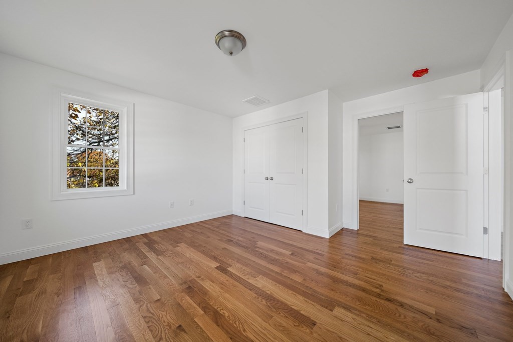 1 Northway Road Randolph, MA 02368 - Photo 20 of 40 an empty room with wooden floor and windows