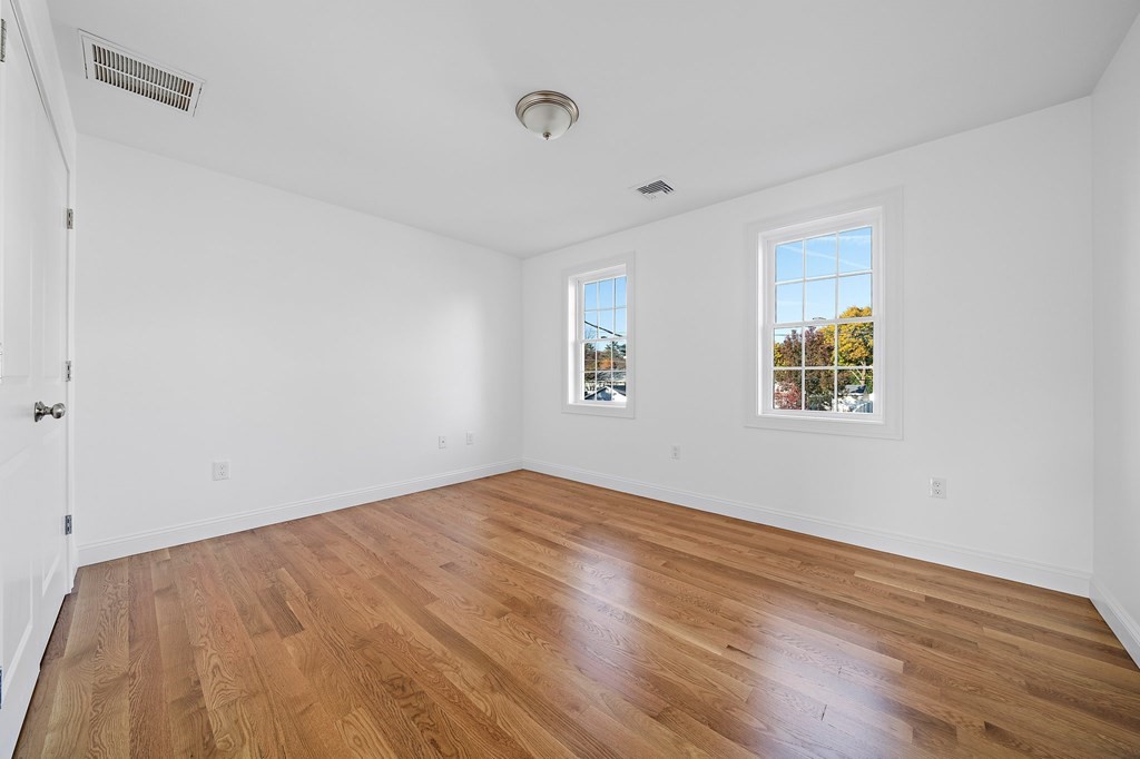 1 Northway Road Randolph, MA 02368 - Photo 23 of 40 an empty room with wooden floor and windows