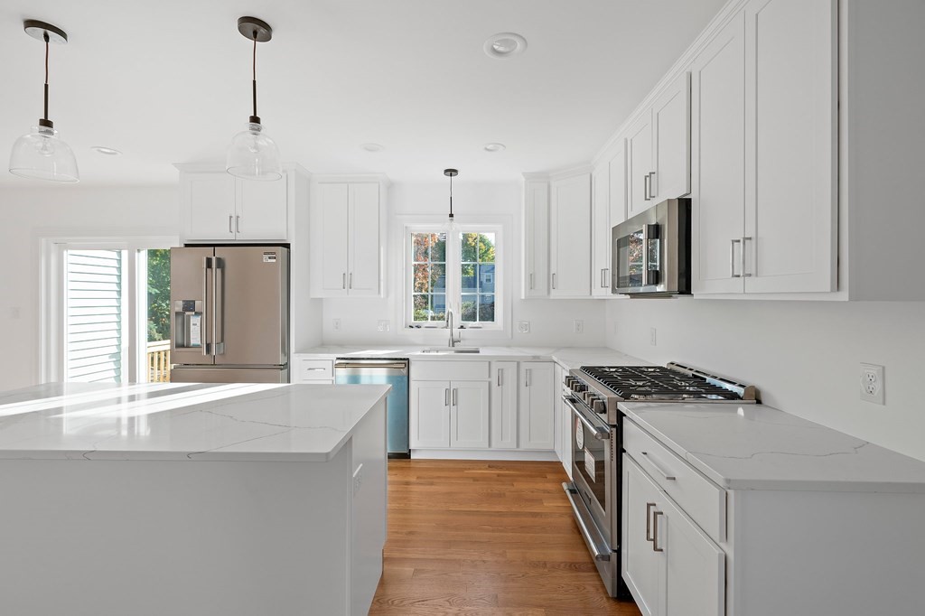 1 Northway Road Randolph, MA 02368 - Photo 6 of 40 a kitchen with granite countertop a sink stove and refrigerator