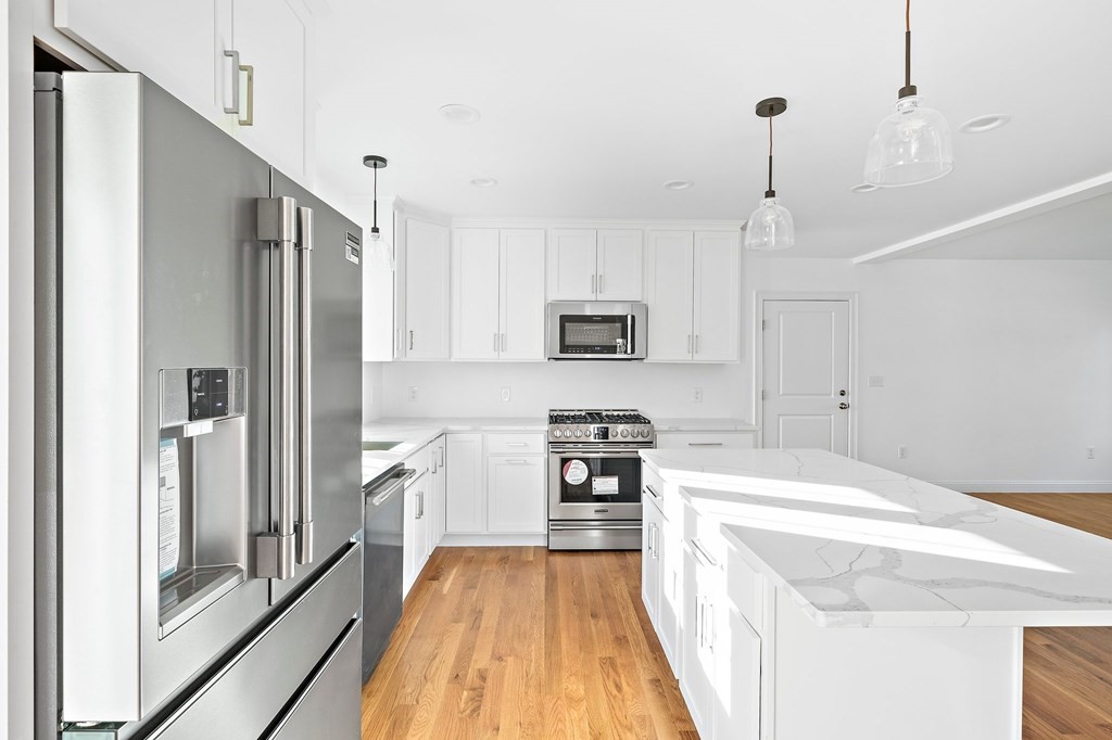 1 Northway Road Randolph, MA 02368 - Photo 8 of 40 a kitchen with stainless steel appliances a refrigerator sink and microwave